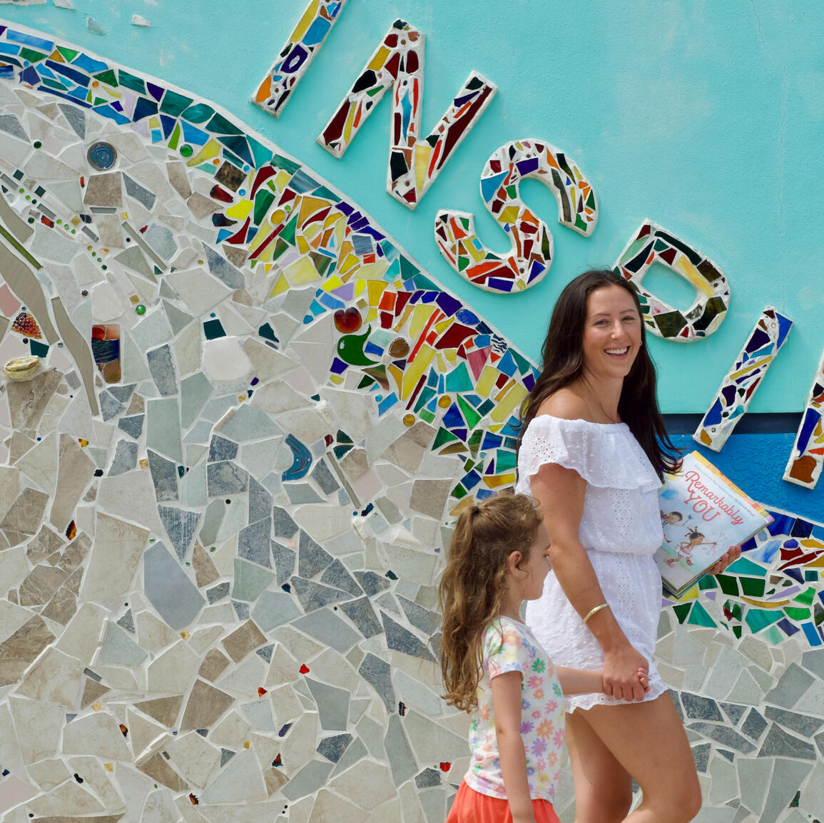 Inspire Young Students to Read Miss Jenna walking with young girl student to tutoring.